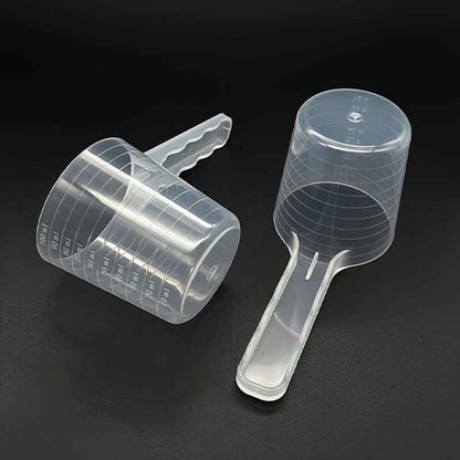 Cuillère de nourriture transparente pour chiens et chats avec marques de mesure. Plastique durable, manche ergonomique, facile à nettoyer. Idéale pour aliments secs, humides, compléments et lait en poudre